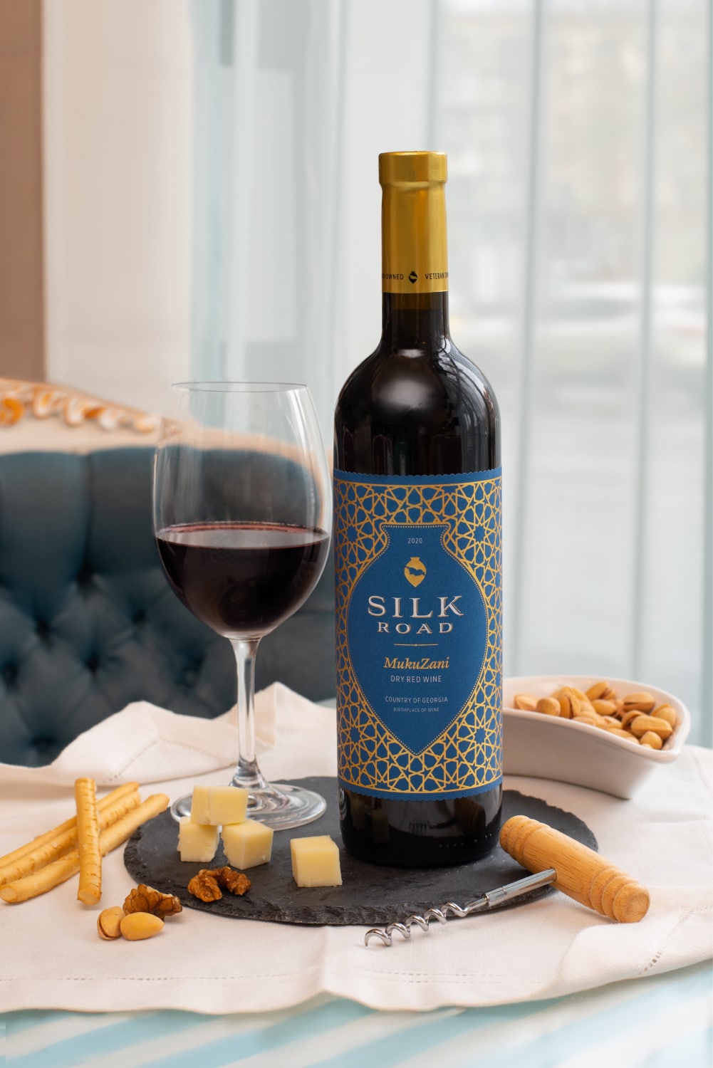 Silk Road Mukuzani Wine Served with Cheese, Nuts, and Breadsticks